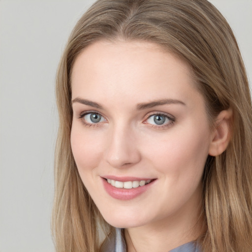 Joyful white young-adult female with long  brown hair and blue eyes