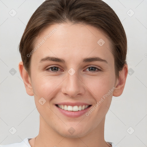 Joyful white young-adult female with short  brown hair and grey eyes