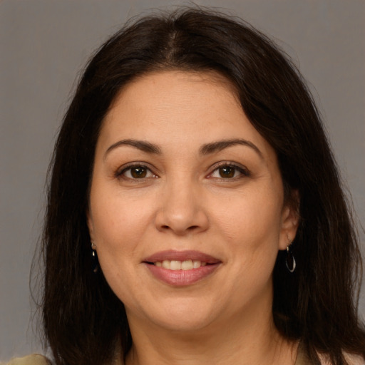 Joyful white adult female with long  brown hair and brown eyes