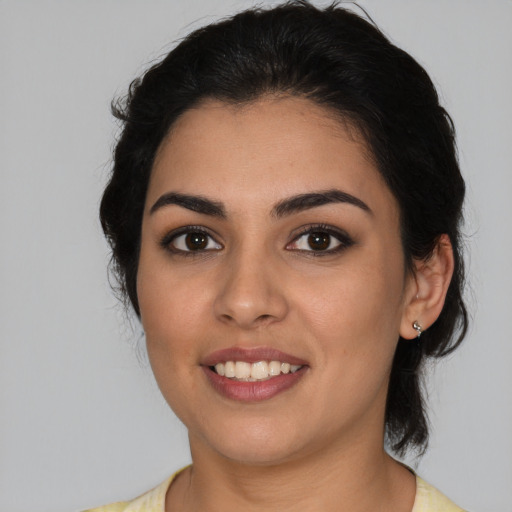 Joyful latino young-adult female with medium  black hair and brown eyes