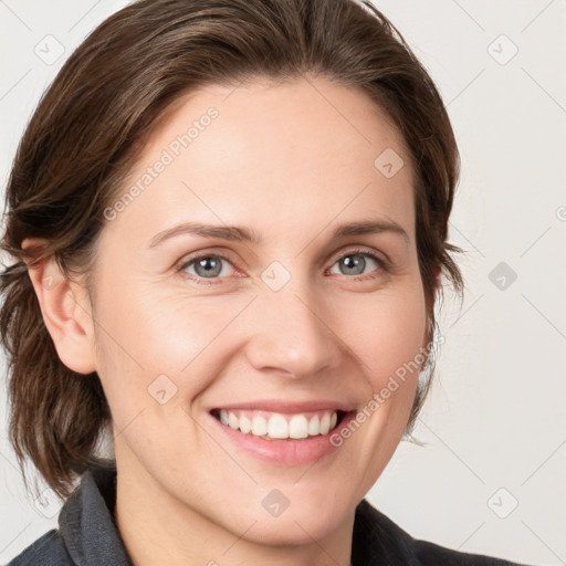 Joyful white young-adult female with medium  brown hair and grey eyes