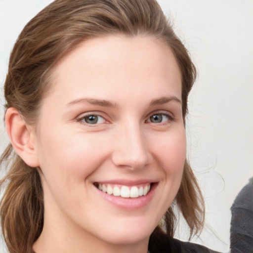 Joyful white young-adult female with medium  brown hair and blue eyes