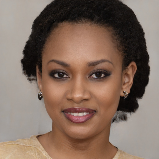 Joyful black young-adult female with short  black hair and brown eyes