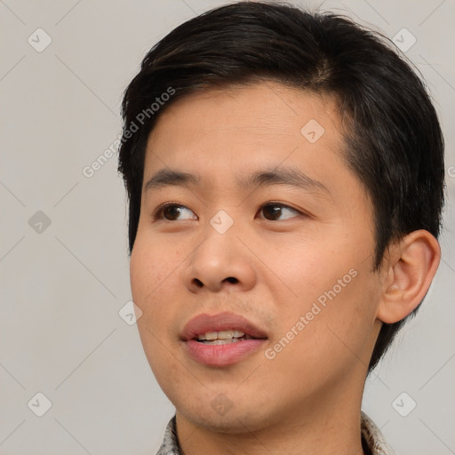 Joyful asian young-adult male with short  brown hair and brown eyes