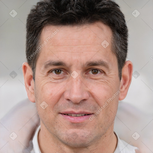 Joyful white adult male with short  brown hair and brown eyes