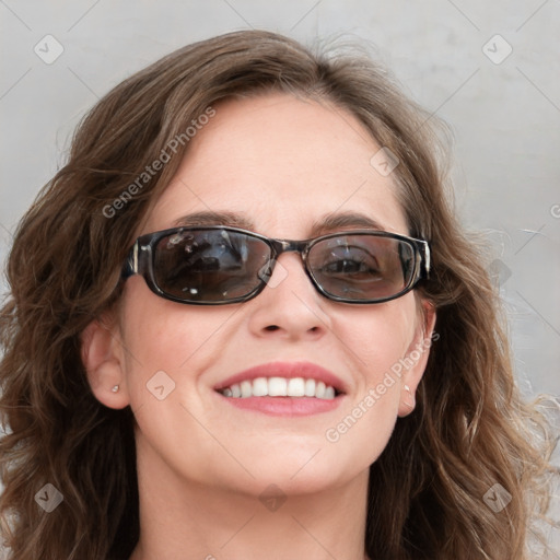 Joyful white young-adult female with long  brown hair and blue eyes