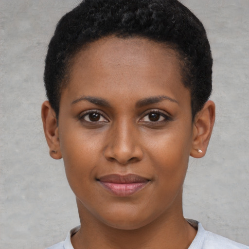 Joyful black young-adult female with short  brown hair and brown eyes