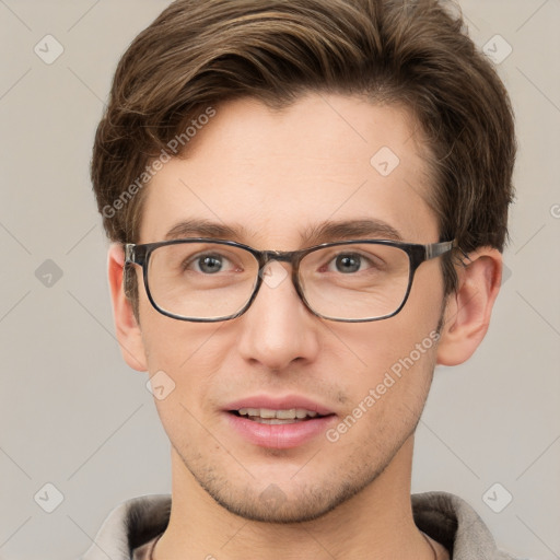 Joyful white adult male with short  brown hair and grey eyes