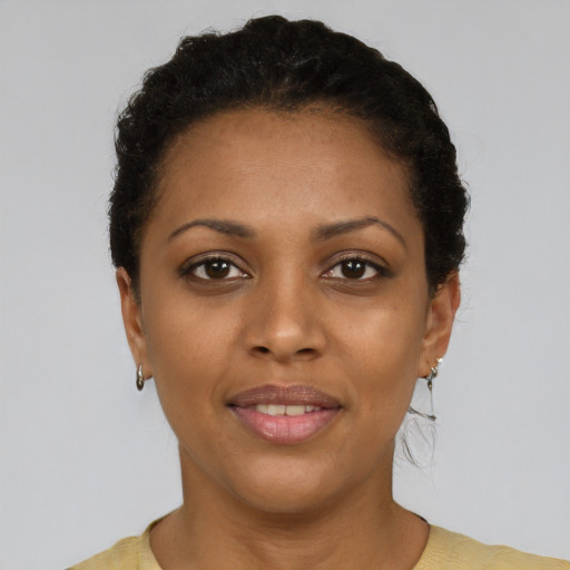 Joyful black young-adult female with short  black hair and brown eyes