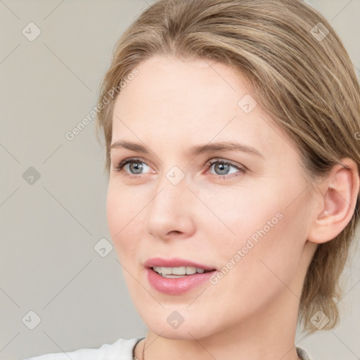 Joyful white young-adult female with medium  brown hair and blue eyes