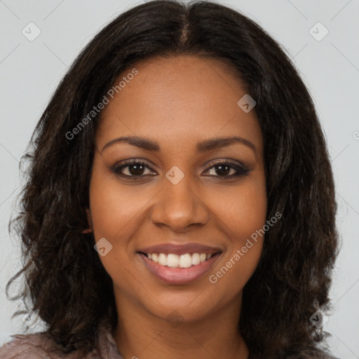 Joyful black young-adult female with long  brown hair and brown eyes