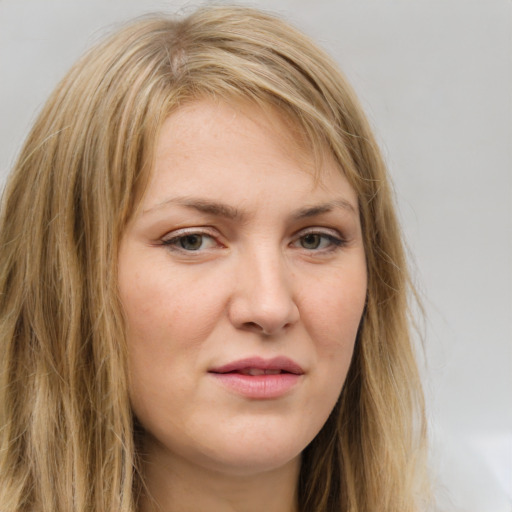 Joyful white young-adult female with long  brown hair and green eyes