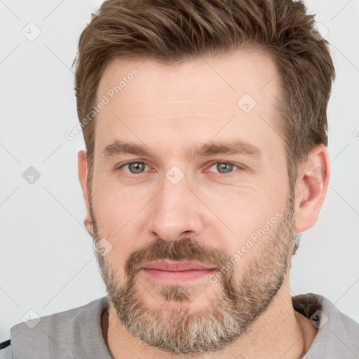 Joyful white adult male with short  brown hair and grey eyes