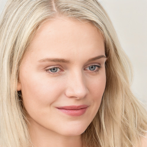 Joyful white young-adult female with long  brown hair and blue eyes