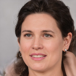 Joyful white adult female with medium  brown hair and brown eyes