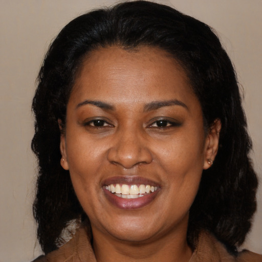 Joyful black adult female with medium  black hair and brown eyes