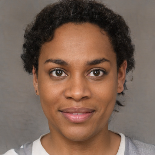 Joyful black young-adult female with short  brown hair and brown eyes