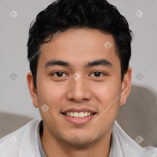 Joyful asian young-adult male with short  brown hair and brown eyes