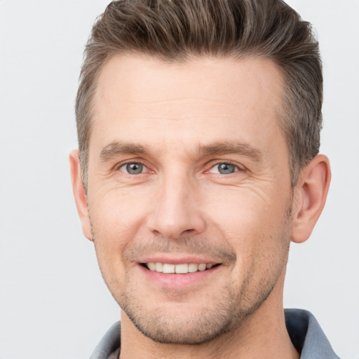 Joyful white adult male with short  brown hair and brown eyes