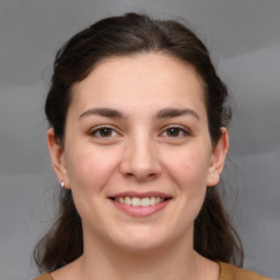 Joyful white young-adult female with medium  brown hair and brown eyes