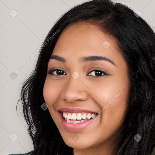 Joyful latino young-adult female with long  black hair and brown eyes