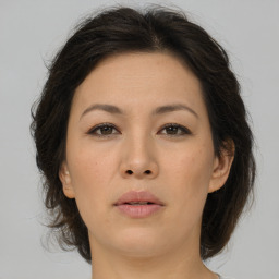 Joyful asian young-adult female with medium  brown hair and brown eyes