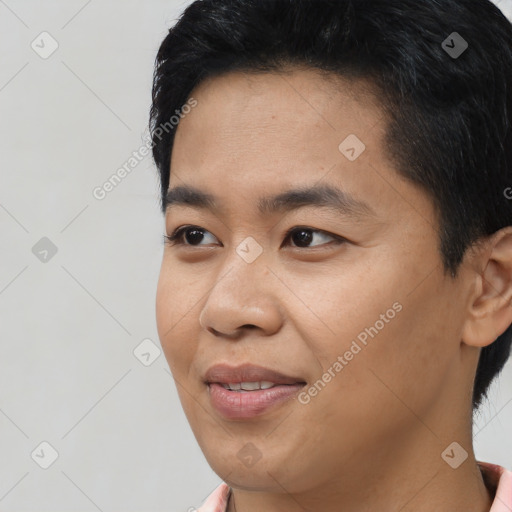 Joyful asian young-adult male with short  black hair and brown eyes