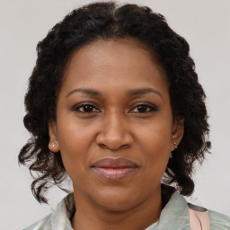 Joyful black adult female with medium  brown hair and brown eyes