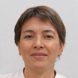 Joyful white adult female with short  brown hair and brown eyes