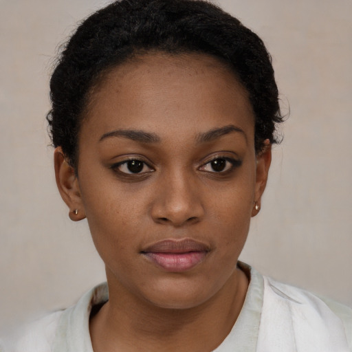 Joyful black young-adult female with short  brown hair and brown eyes