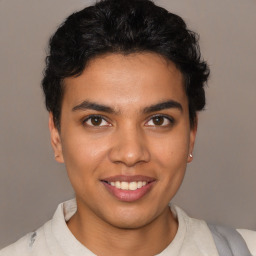 Joyful latino young-adult male with short  brown hair and brown eyes