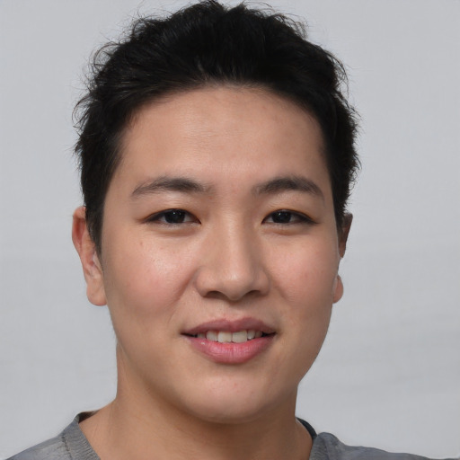 Joyful asian young-adult male with short  brown hair and brown eyes