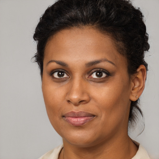 Joyful black young-adult female with medium  brown hair and brown eyes