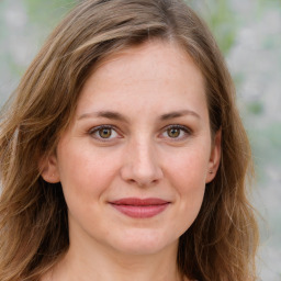 Joyful white young-adult female with long  brown hair and green eyes