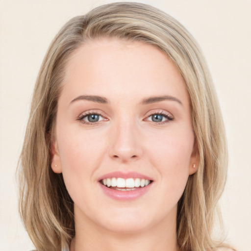 Joyful white young-adult female with long  brown hair and blue eyes