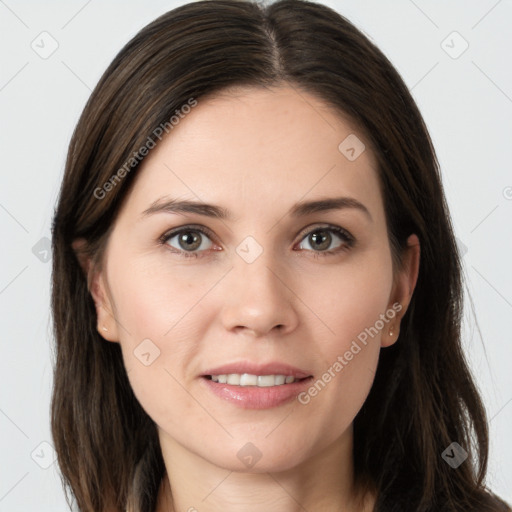 Joyful white young-adult female with long  brown hair and brown eyes