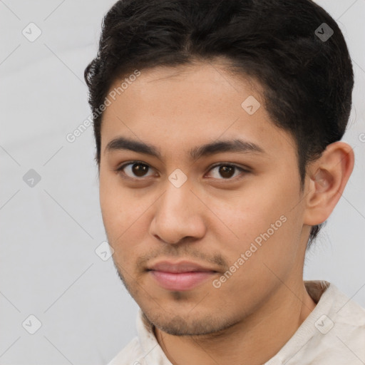 Joyful latino young-adult male with short  brown hair and brown eyes