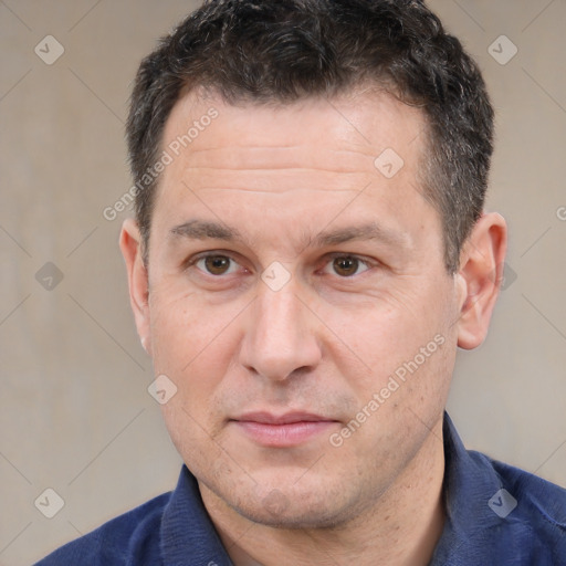 Joyful white adult male with short  brown hair and brown eyes