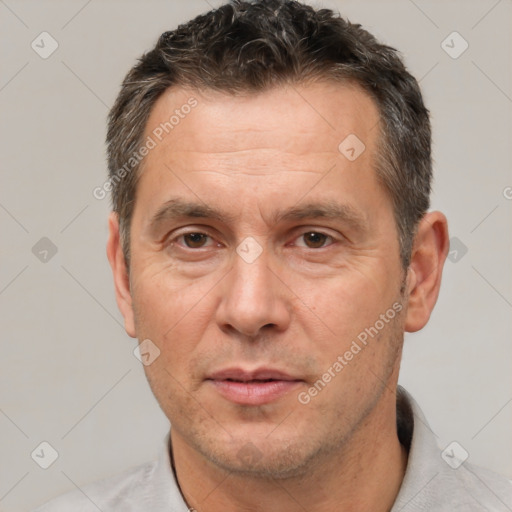 Joyful white adult male with short  brown hair and brown eyes