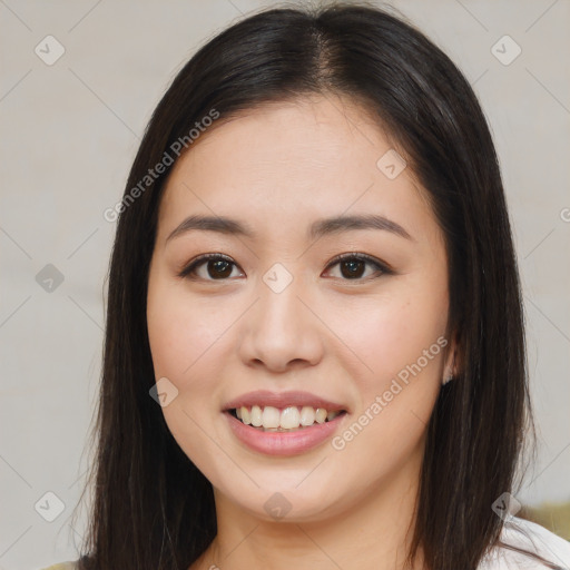 Joyful asian young-adult female with long  brown hair and brown eyes