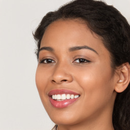Joyful latino young-adult female with long  brown hair and brown eyes