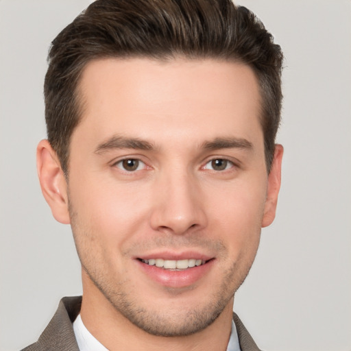 Joyful white young-adult male with short  brown hair and brown eyes