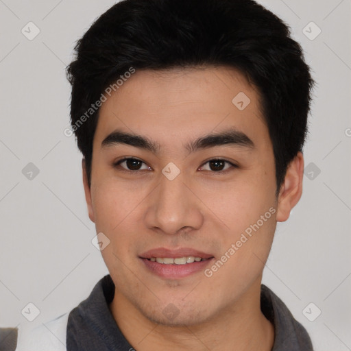 Joyful asian young-adult male with short  black hair and brown eyes