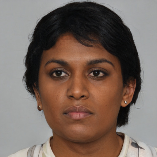 Neutral black young-adult female with medium  black hair and brown eyes