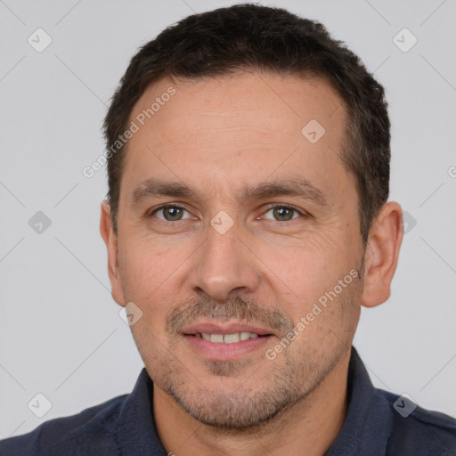 Joyful white adult male with short  brown hair and brown eyes