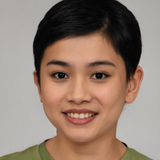 Joyful asian young-adult female with short  black hair and brown eyes