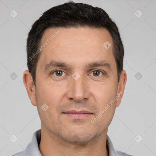 Joyful white adult male with short  brown hair and brown eyes