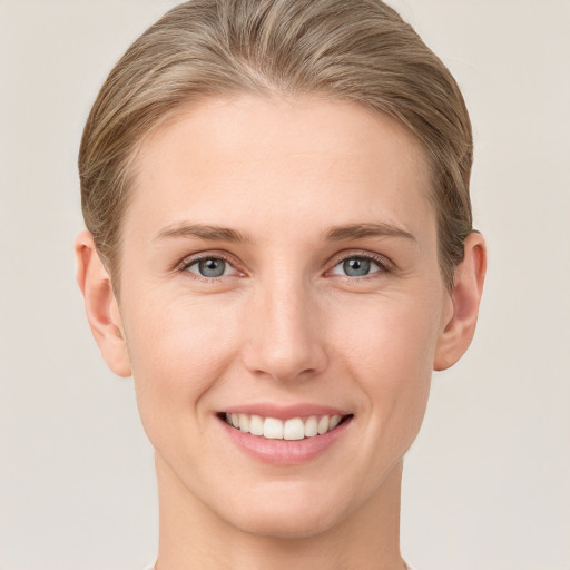 Joyful white young-adult female with short  brown hair and grey eyes