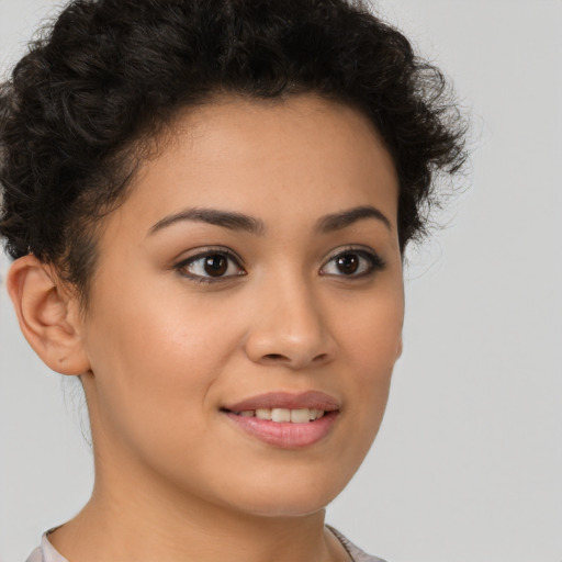 Joyful latino young-adult female with short  brown hair and brown eyes