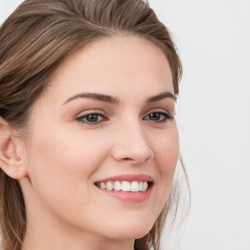 Joyful white young-adult female with long  brown hair and grey eyes